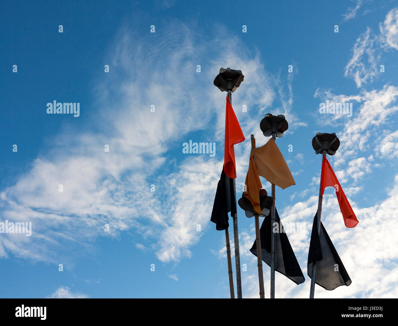 Fishing flags on pot markers  against a blue sky Stock Photo