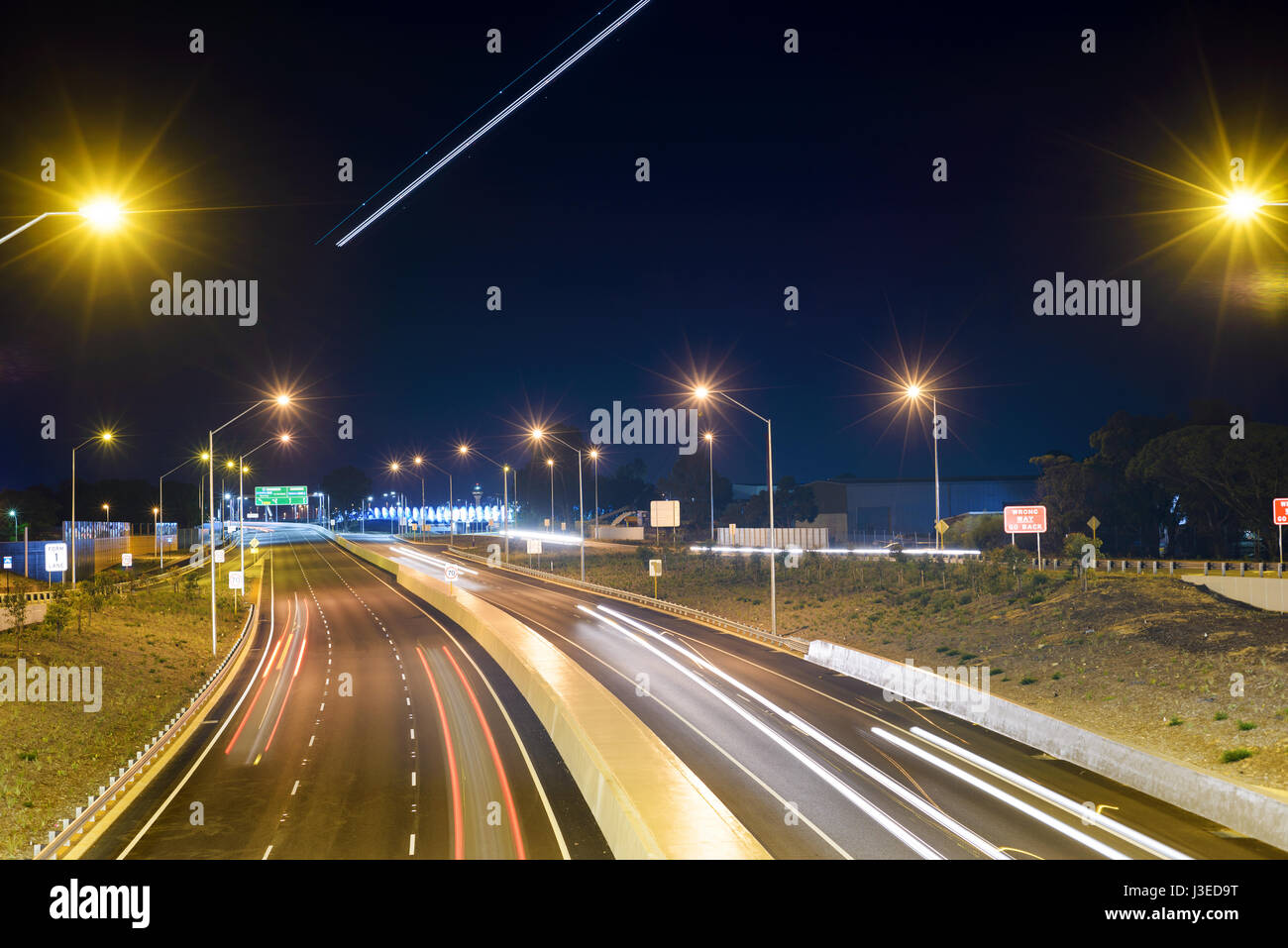 Air traffic over road, Highway in Perth, night, Tonkin Highway, illuminated, Western Australia, Australia Stock Photo