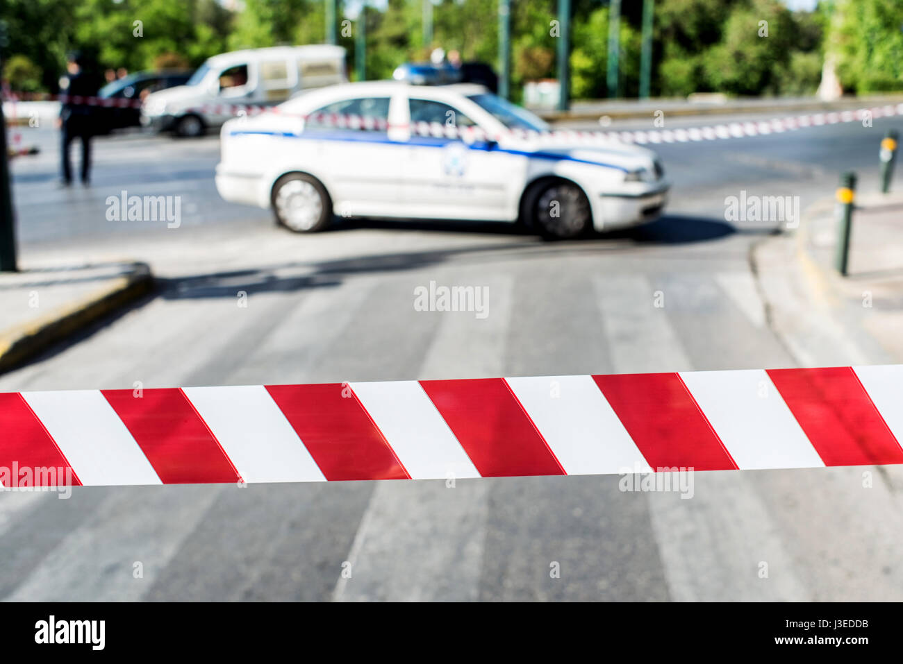 Red and white striped security tape of police Stock Photo - Alamy