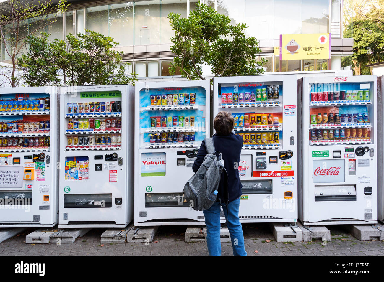 Senior european woman chosing from a large array of vending machines. Stock Photo