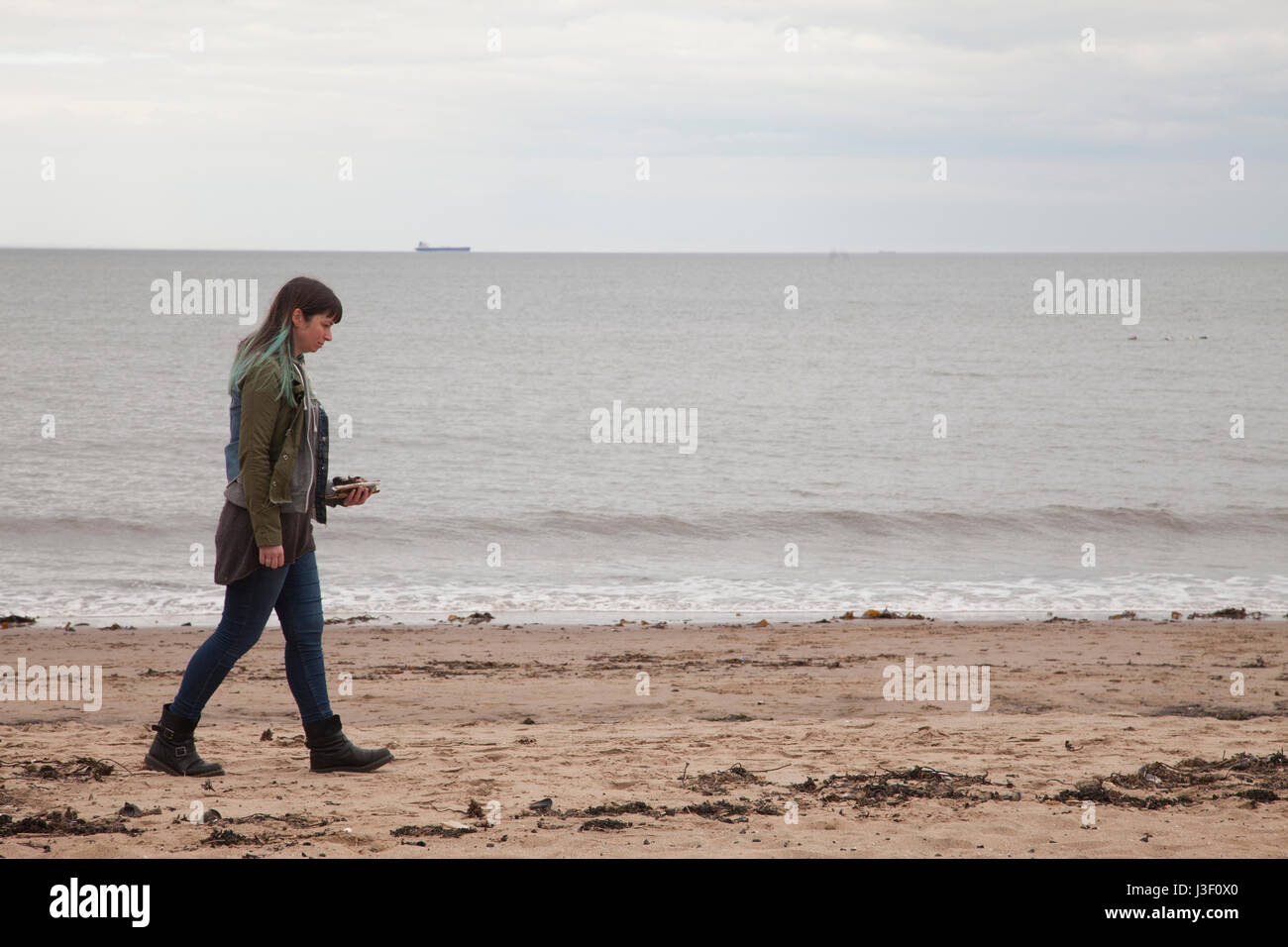 People walking on Portobello beach in capital of Scotland, Edinburgh