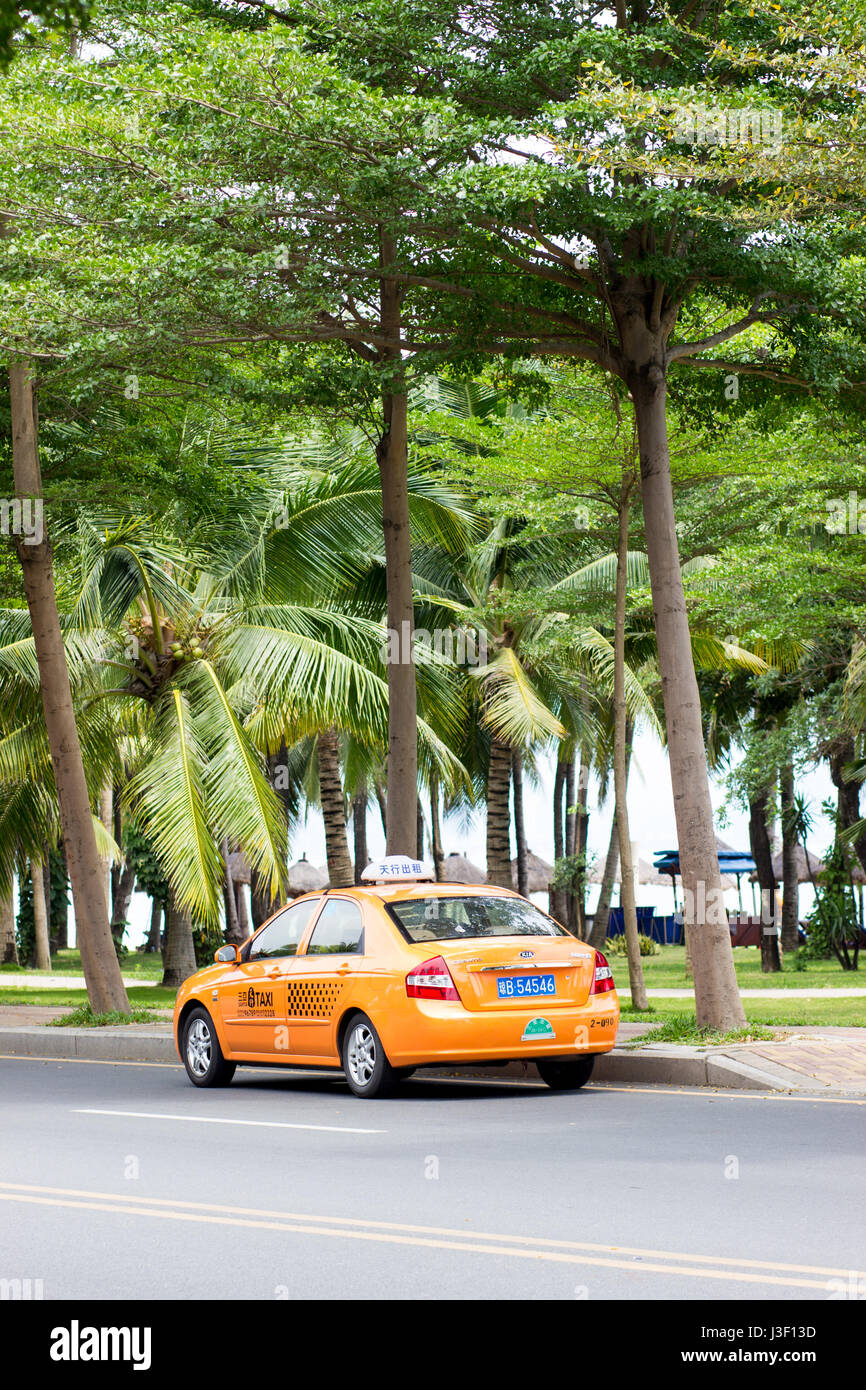 Sanya, Hainan, China April 24, 2017 - Kia Cerato car, taxi service, stands on the roadside along the asphalt road along the coastline Stock Photo