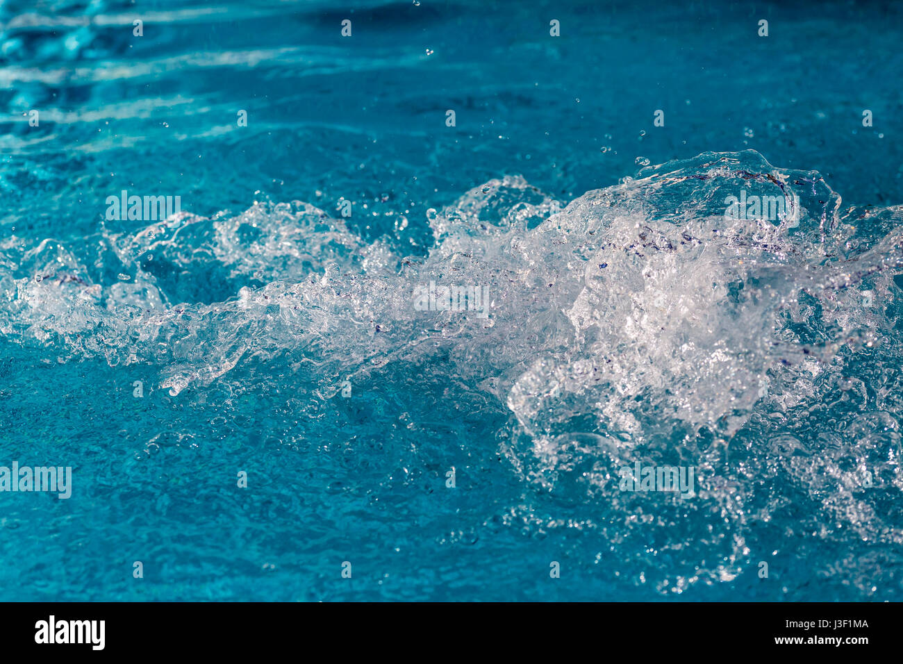 Splash of a inflowing water jet into a swimming pool Stock Photo - Alamy