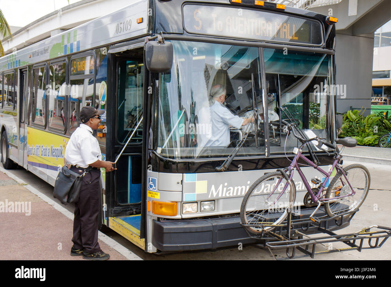 Miami Florida,Omni Bus Station,Metrobus,bicycle,bicycling,riding,biking,rider,bike,mass transit,commuter,commuters,bike rack,board,Black woman female Stock Photo