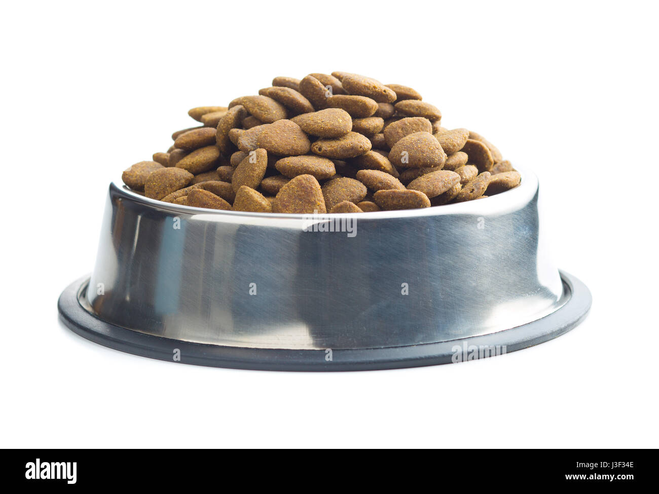 Dry kibble dog food in metal bowl isolated on white background Stock