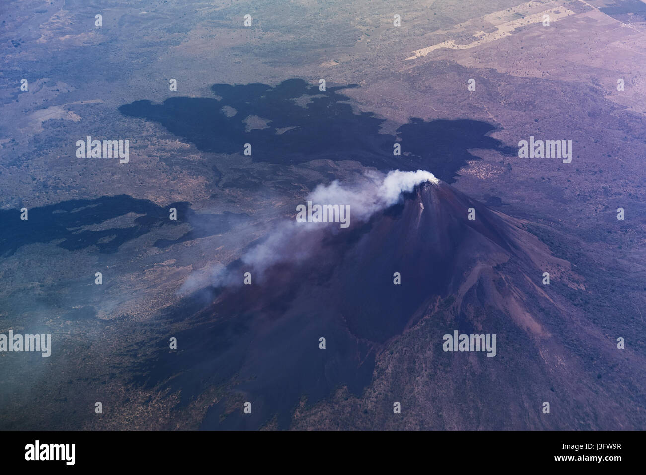 Volcano with smoke in crater aerial view. Momotombo volcano in nicaragua landscape Stock Photo