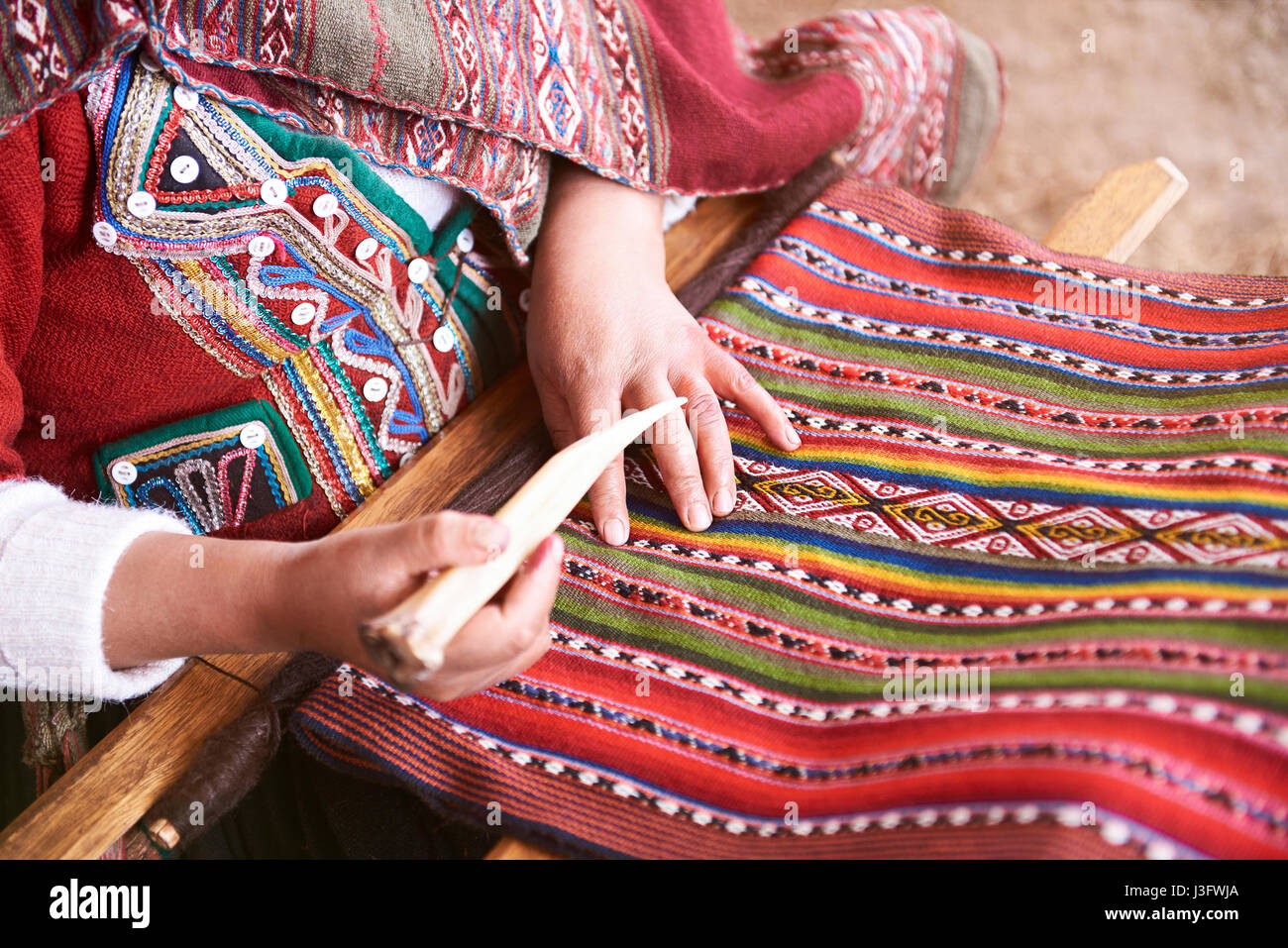 Handmade traditional colorful wool. Peru woman make alpaca textile close-up Stock Photo