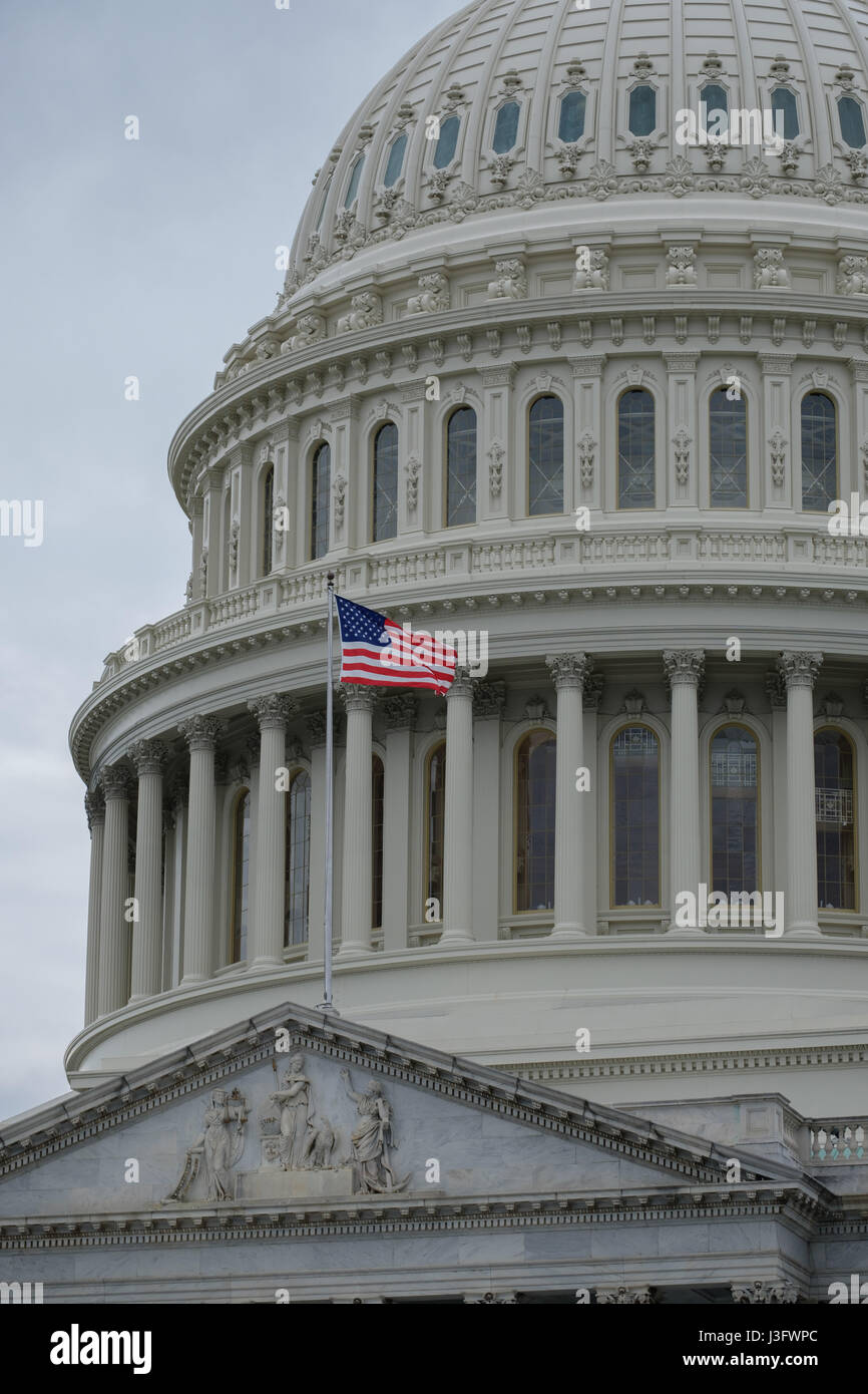 Closeup of U.S. Capitol Dome with waving American flag Stock Photo - Alamy
