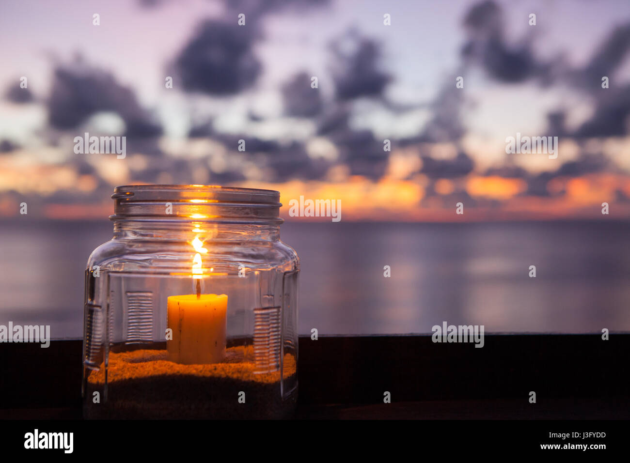 Candle lamp on wooden table with sea and sunset background, romantic dinner  in the restaurant. Indonesia Bali Stock Photo - Alamy