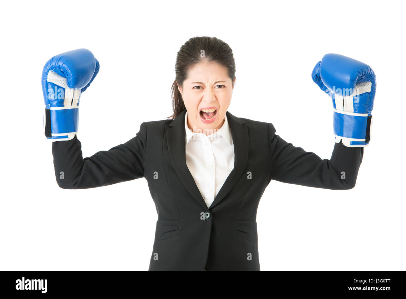 Boxing gloves business woman angry showing aggressive female businessperson flexing muscles wearing boxing gloves isolated on white background. young  Stock Photo