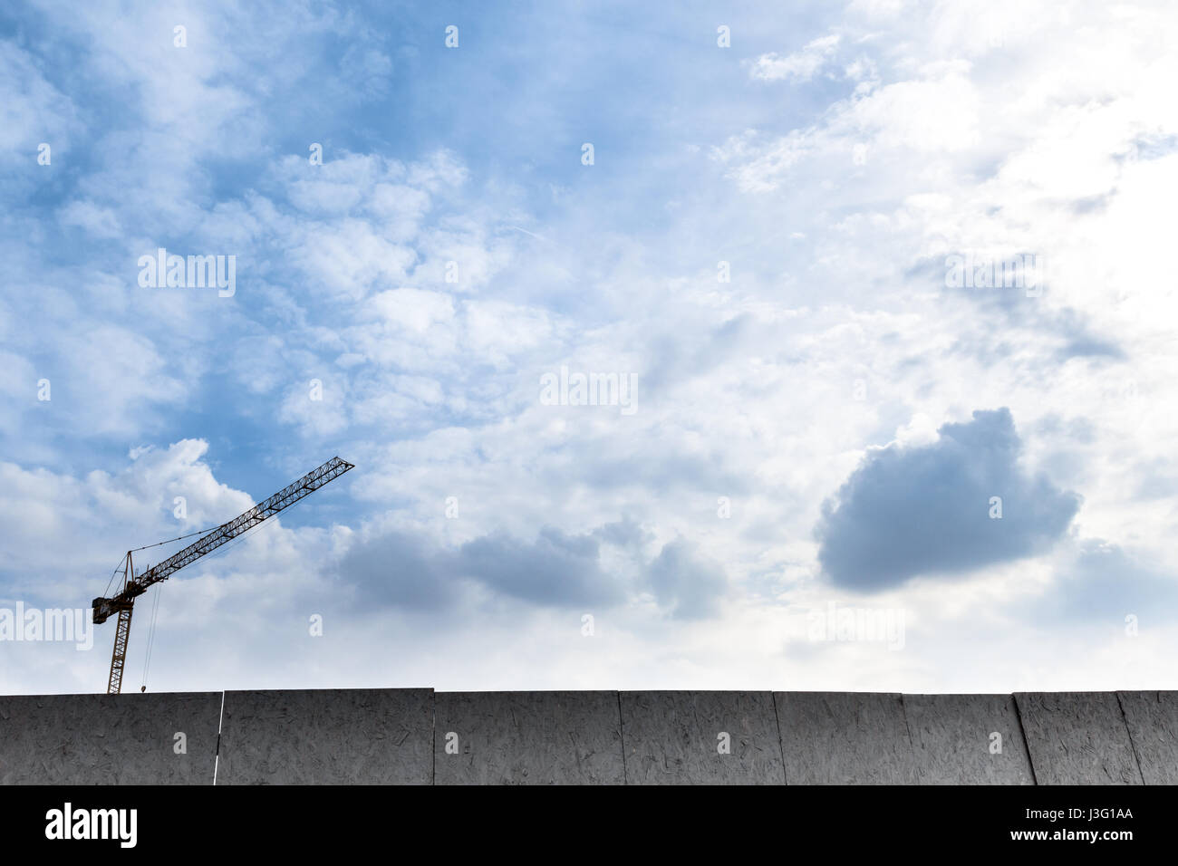 Crane used in construction site with blue sky and clouds Stock Photo ...