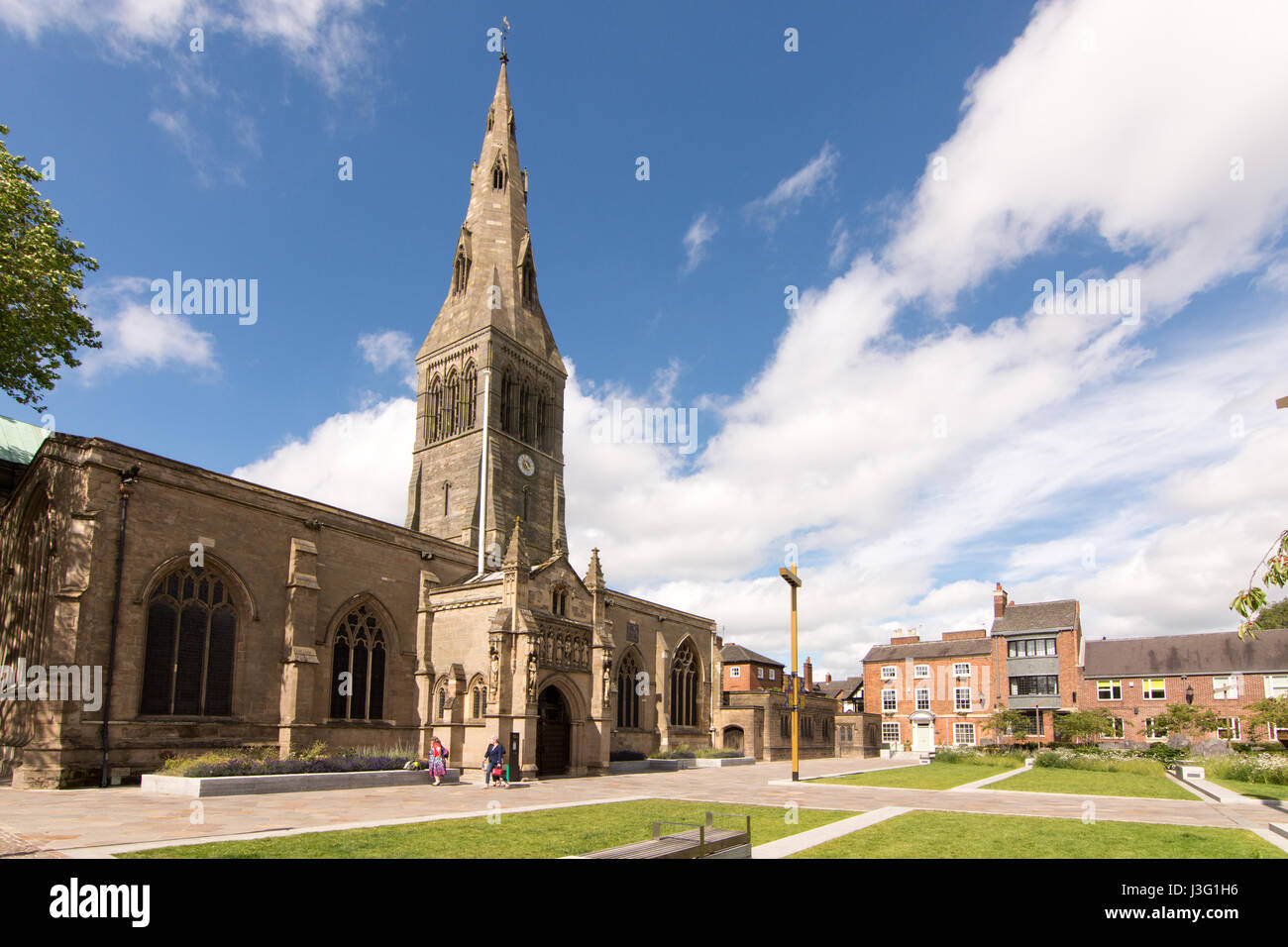 Leicester, England, UK - June 28, 2015: Pedestrians walk past Leicester Cathedral on a sunny day in summer. Stock Photo