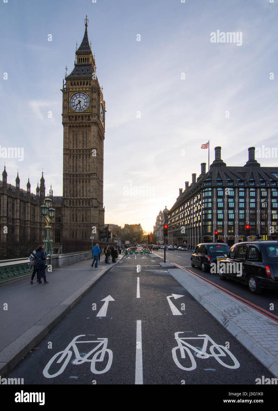 London, England - April 20, 2016: Freshly painted direction signs on the new East-West Cycle Superhighway outside the Houses of Parliament in central  Stock Photo
