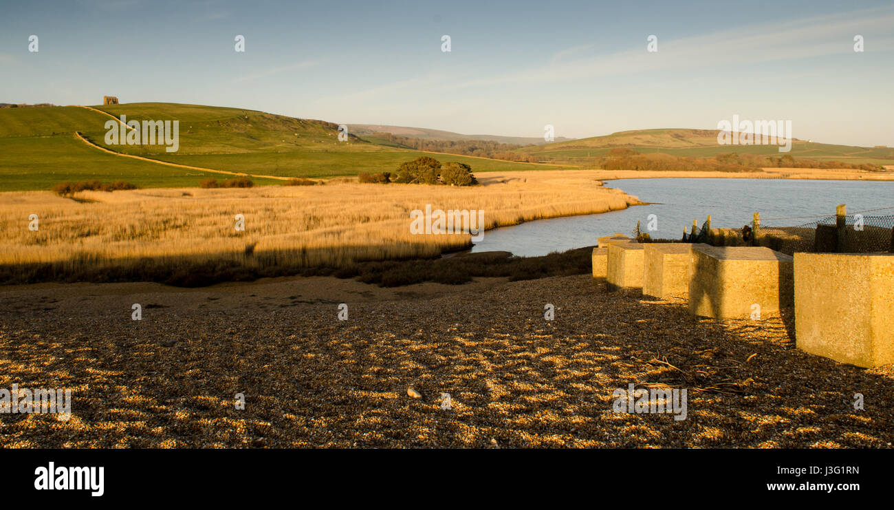 Evening sun illuminates Chesil Beach and The Fleet lagoon on Dorset's