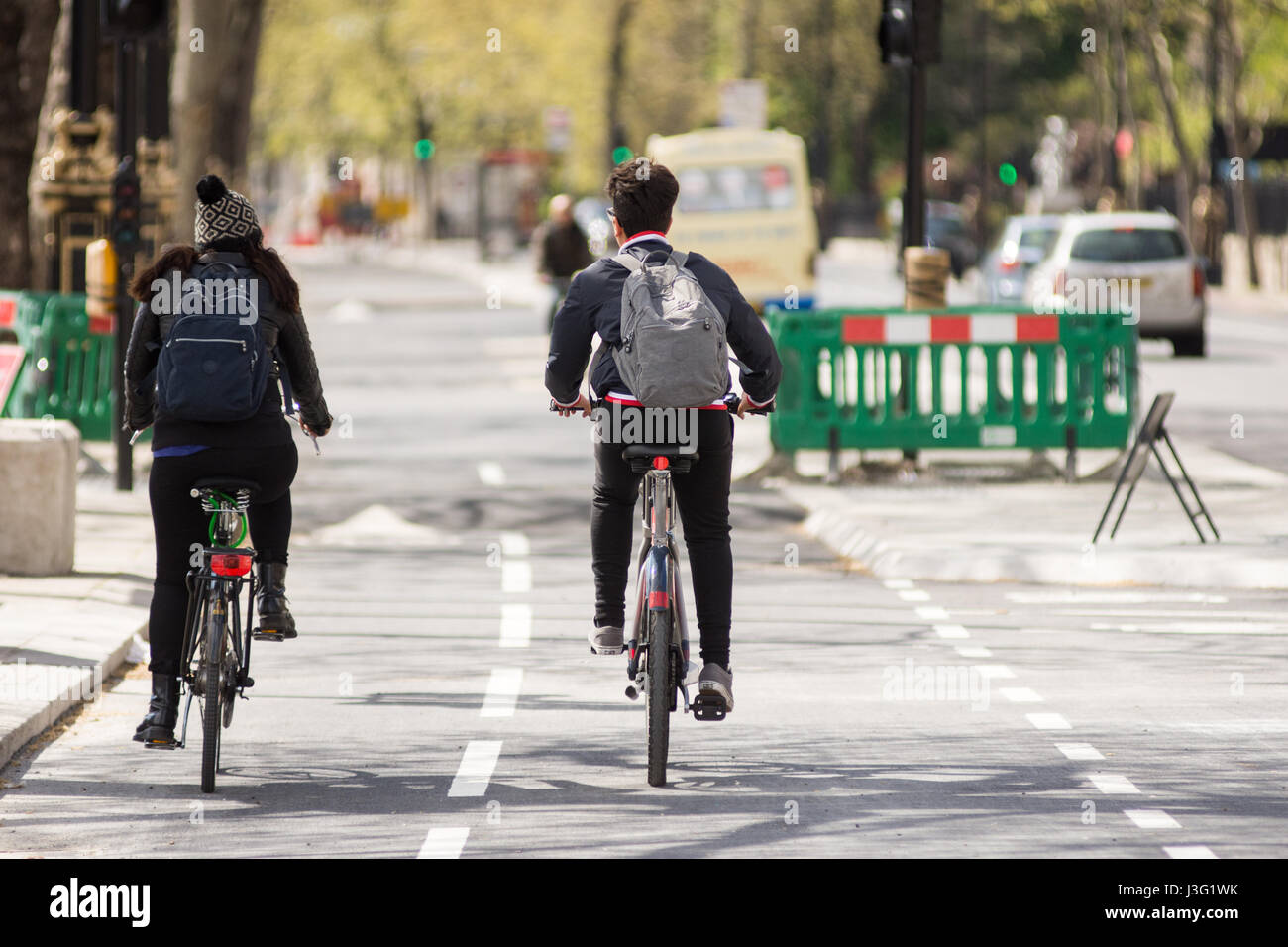 London, England - April 30, 2016: Cyclists using the new East-west Cycle Superhighway, flagship in mayor Boris Johnson's transport policy, ahead of it Stock Photo