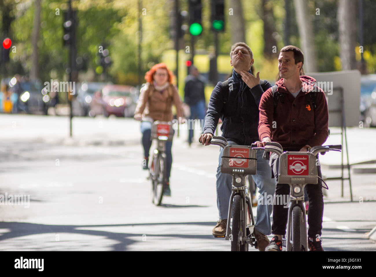 London, England - April 30, 2016: Cyclists using the new East-west Cycle Superhighway, flagship in mayor Boris Johnson's transport policy, ahead of it Stock Photo