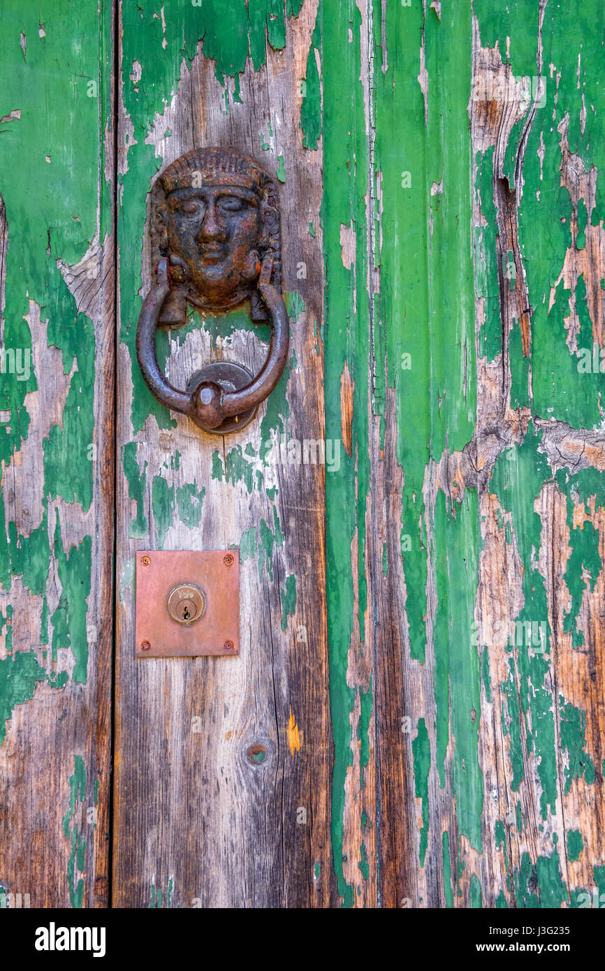 Egyptian Pharaoh door knocker on a wooden door. Stock Photo