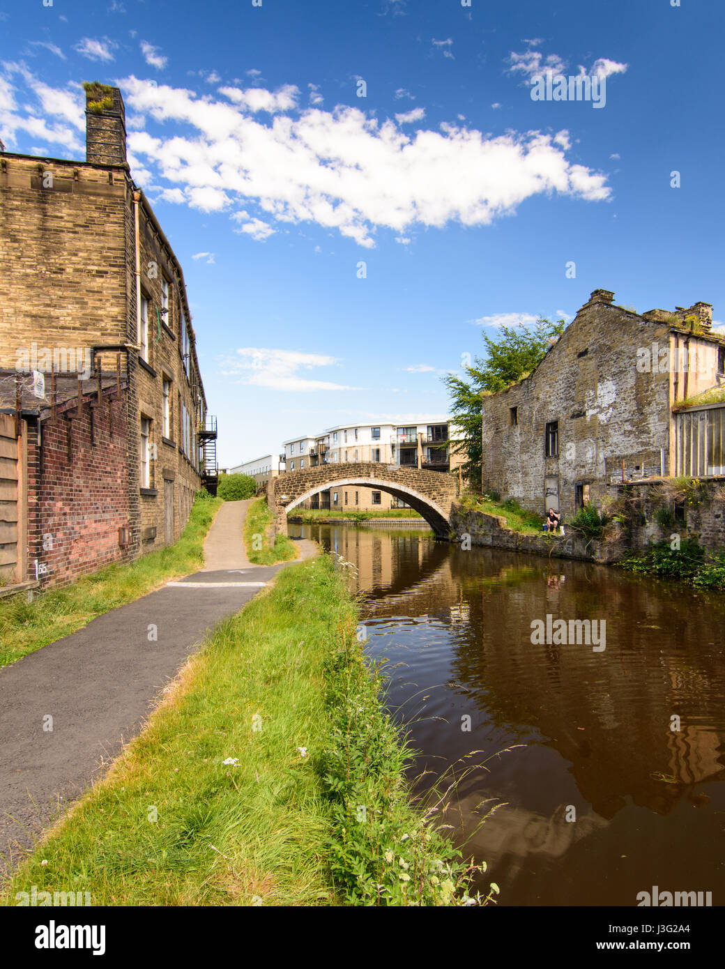 Industrial warehouses line the Leeds and Liverpool Canal at Shipley in the Aire Valley of West Yorkshire. Stock Photo
