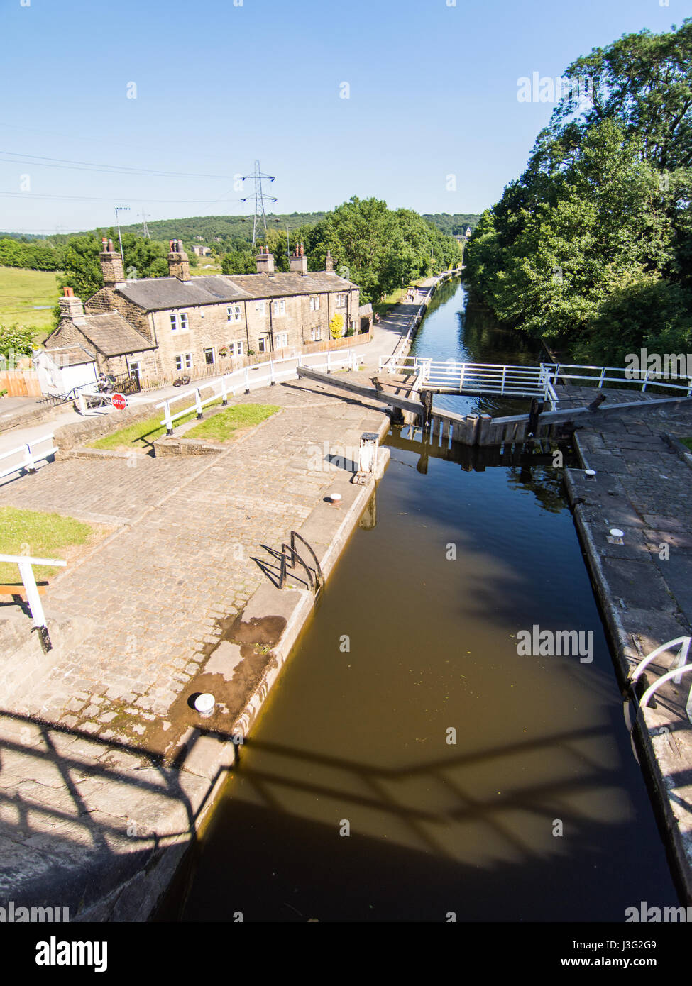 The staircase locks and Lock Keeper's Cottages at Dobson Locks on the Leeds and Liverpool Canal in Leeds/Bradford, Yorkshire. Stock Photo