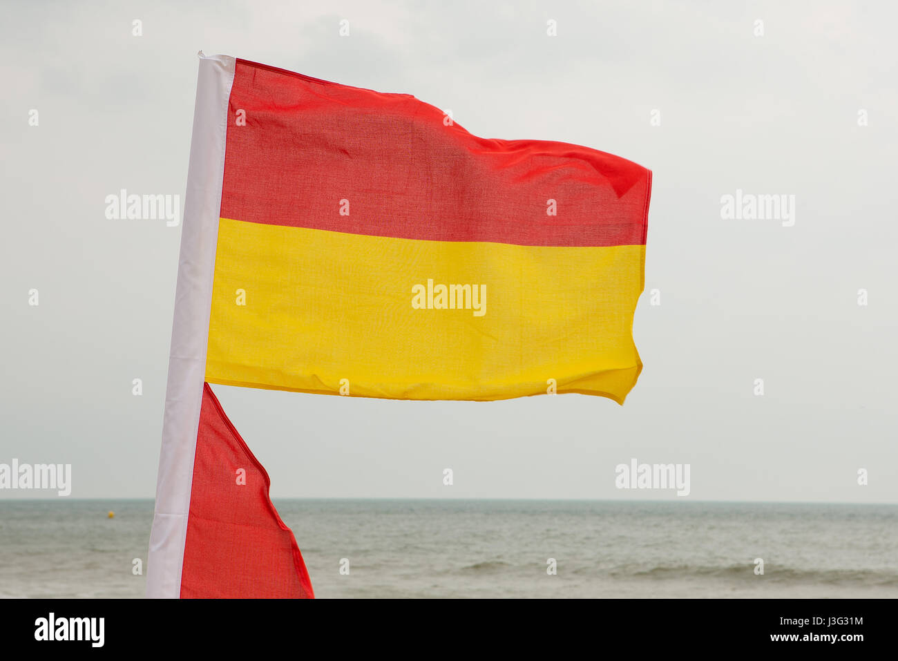 RNLI Lifeguards red and yellow safety flags indicate the safe area for