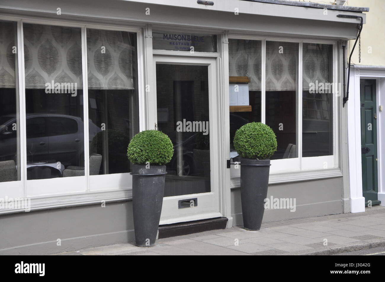 box plants outside Maison Bleue restaurant Stock Photo