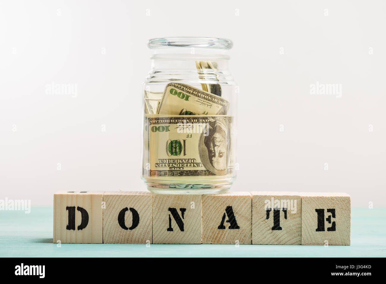 Glass jar with money and text please donate Vector Image