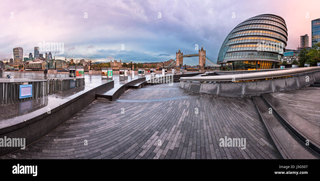 LONDON, UNITED KINGDOM - OCTOBER 7, 2014: London City Hall and Tower Bridge in London, UK. The City Hall has an unusual, bulbous shape, was designed b Stock Photo