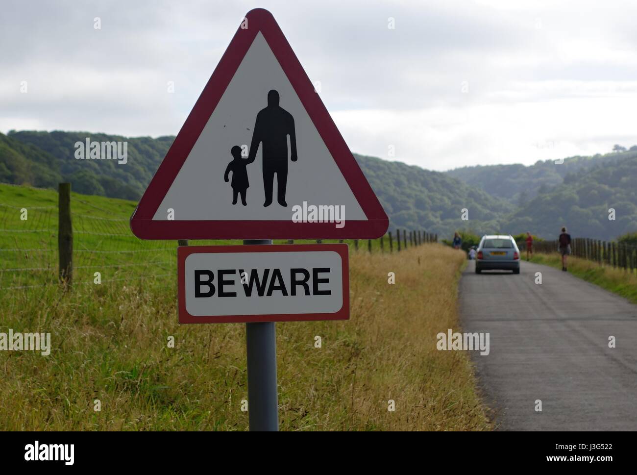 Warning sign pedestrians in road Stock Photo
