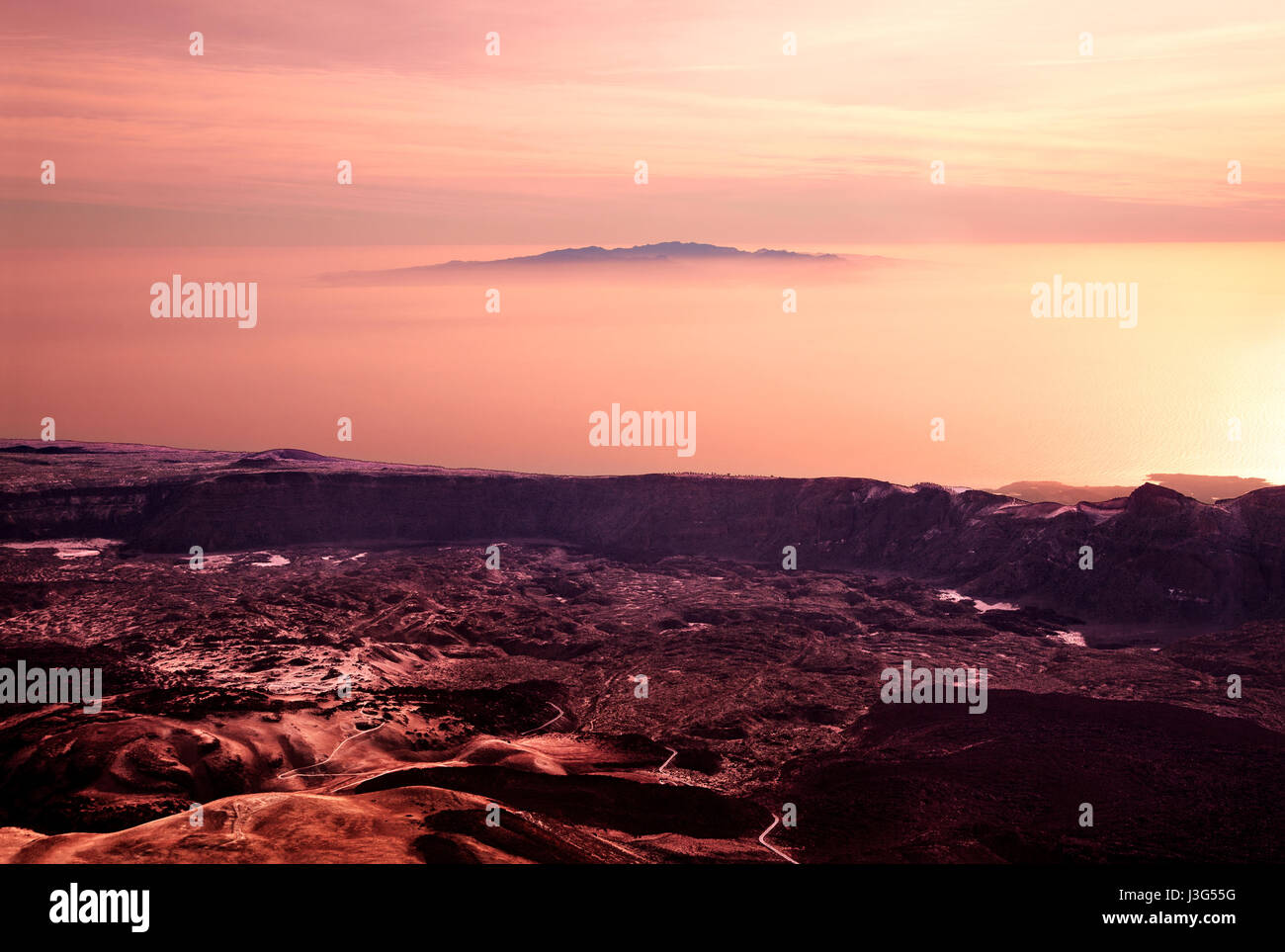 Dramatic volcanic landscape with traces of lava streams on the Island Tenerife, Island Gran Canaria in the horizon, Canary Islands, Spain. Stock Photo