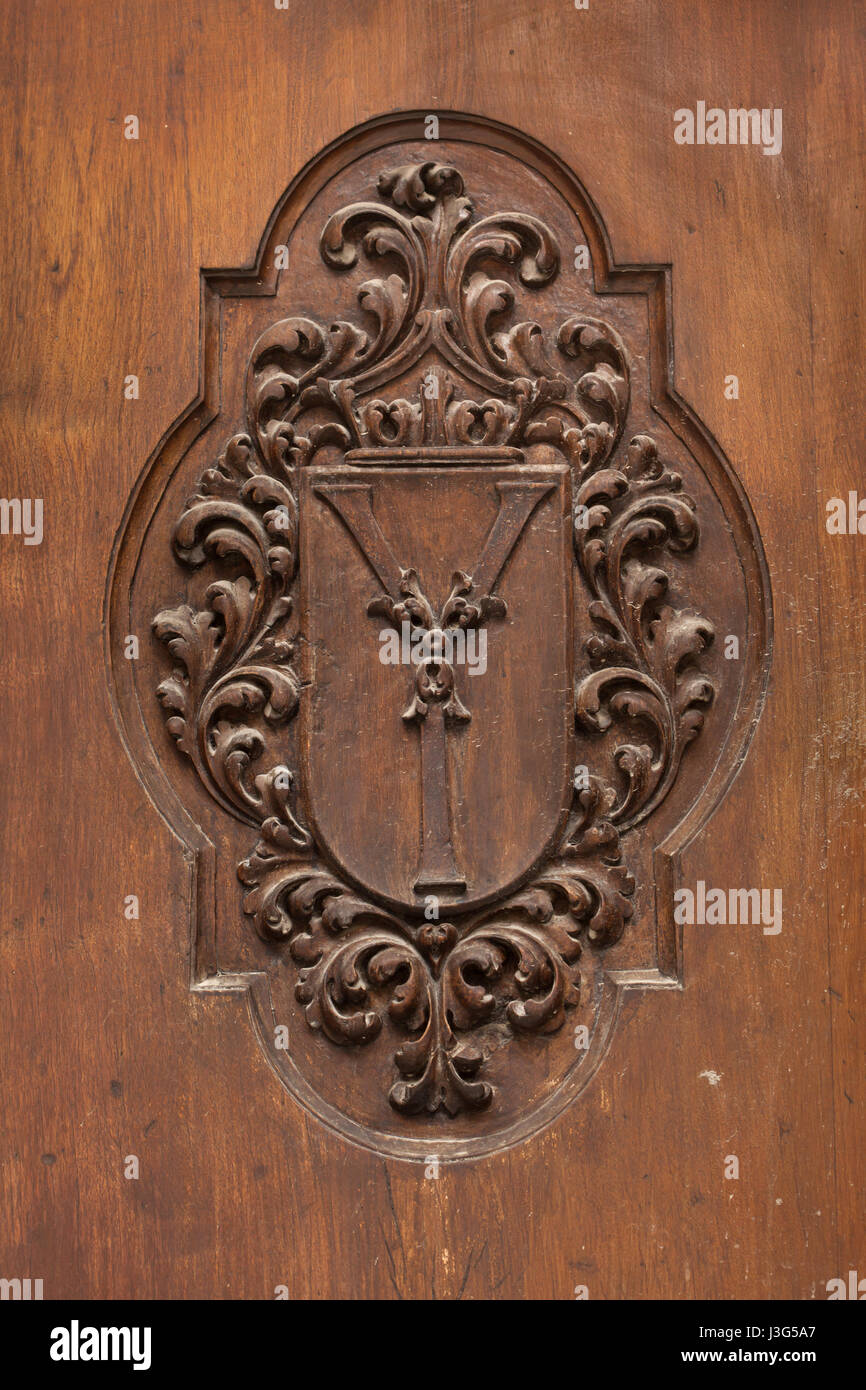 Royal monogram of Queen Isabella I of Castile depicted on the wooden door of the Royal Chapel (Capilla Real de Granada) where the Catholic Monarchs (Los Reyes Catolicos) are buried in Granada, Andalusia, Spain. Stock Photo