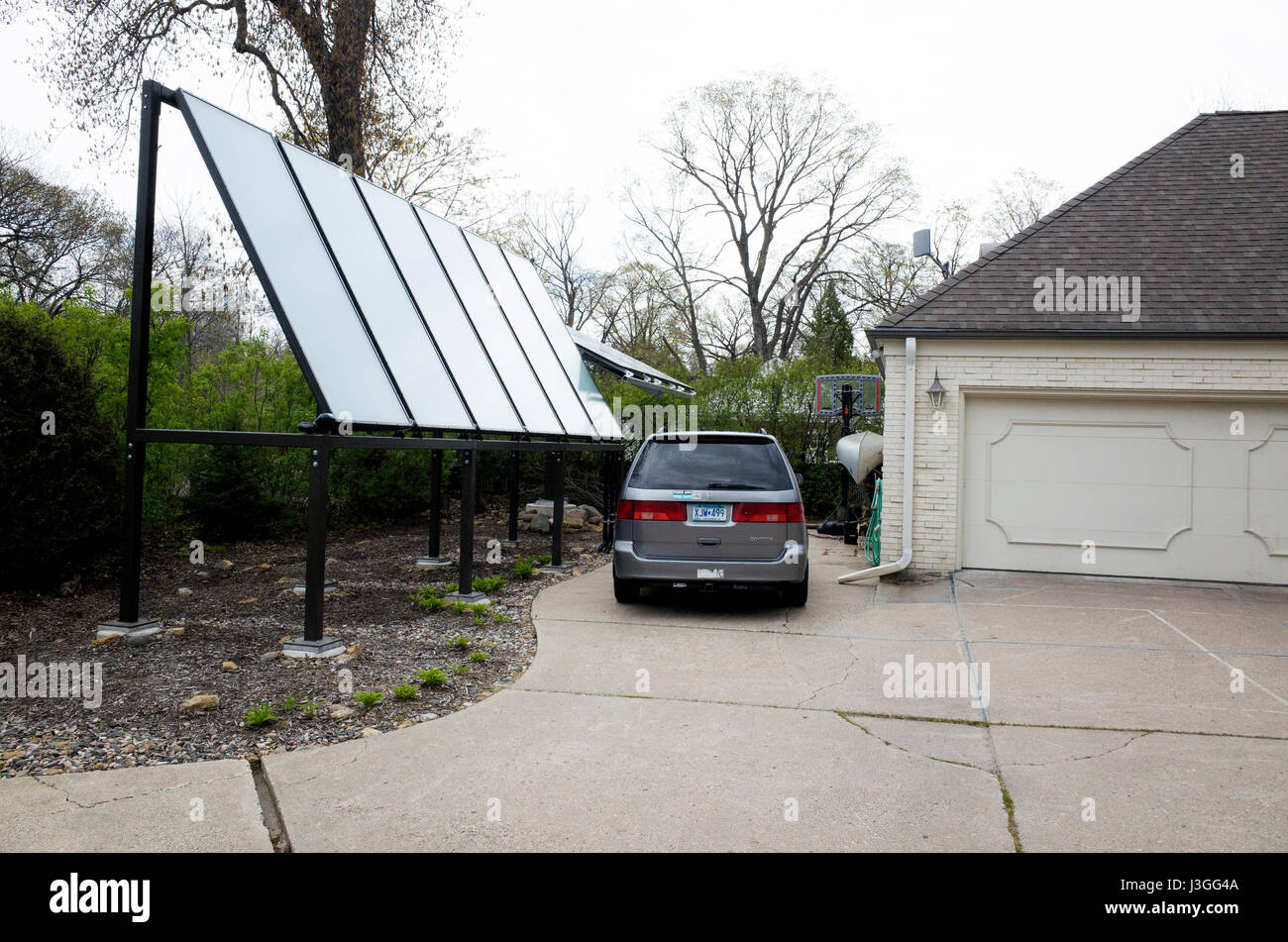 Solar panels beside a garage delivering electricity to a neighborhood home. St Paul Minnesota MN
