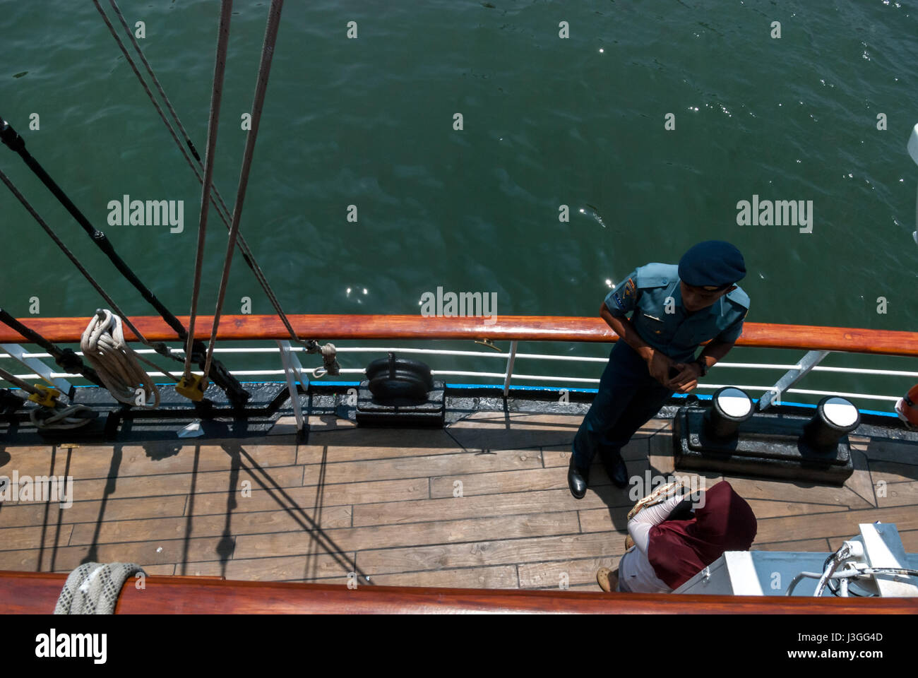 An officer of Indonesian KRI Dewaruci (Dewa Ruci) tall ship giving explanation to a visitor during an 'open house' in Jakarta, Indonesia. Stock Photo