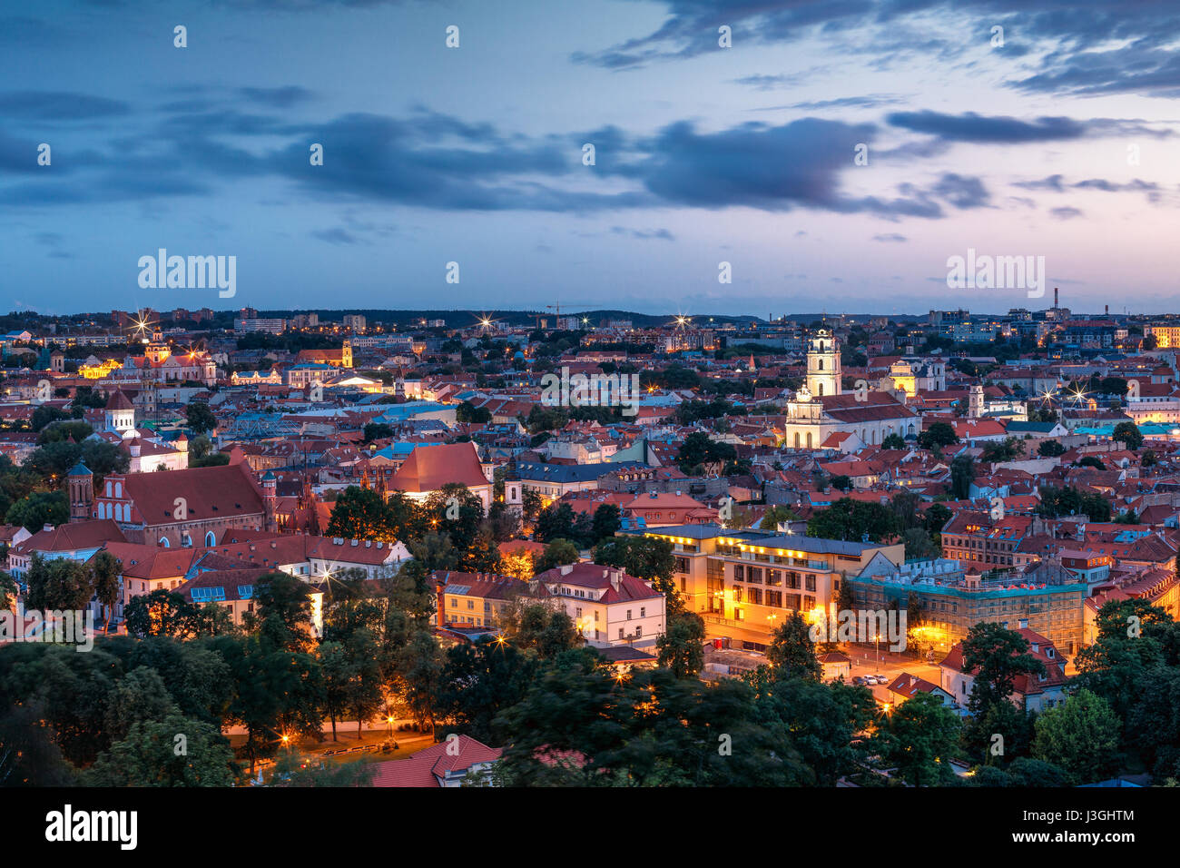 Vilnius, Lithuania. Historic Center Cityscape At Blue Hour After Sunset. Old Town Under Evening Dusk Sky. Travel Panorama In Night Illuminations. UNES Stock Photo