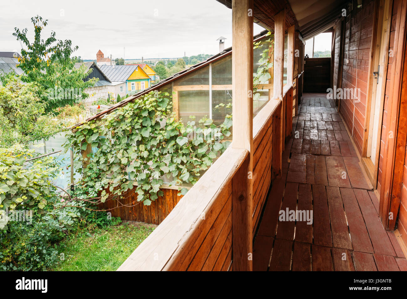 Typical Belarusian Or Russian Wooden Guest House In Village Or Countryside Of Belarus Or Russia Countries At Summer Season. Stock Photo