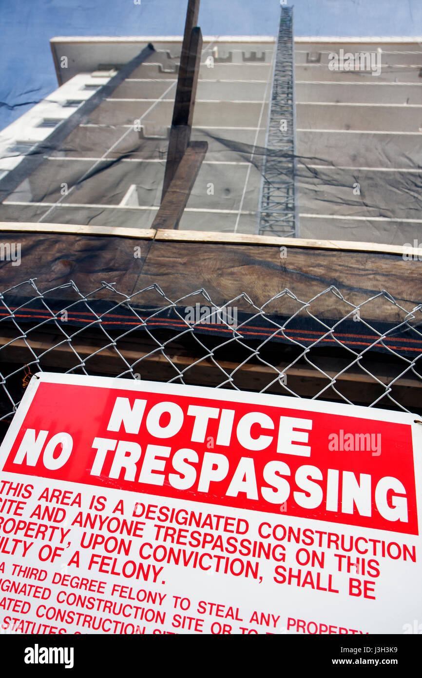Miami Beach Florida,Ocean Drive,building,under new construction site building builder,fence,sign,no trespassing,warning,felony,theft,notice,posted,FL0 Stock Photo