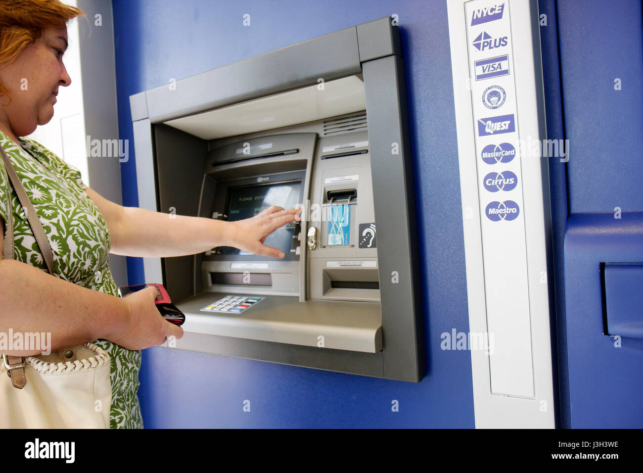 Miami Beach Florida,Wachovia Bank,banking,ATM machine,Hispanic woman female women,currency,money,withdrawal,banking,currency,money,FL080911015 Stock Photo