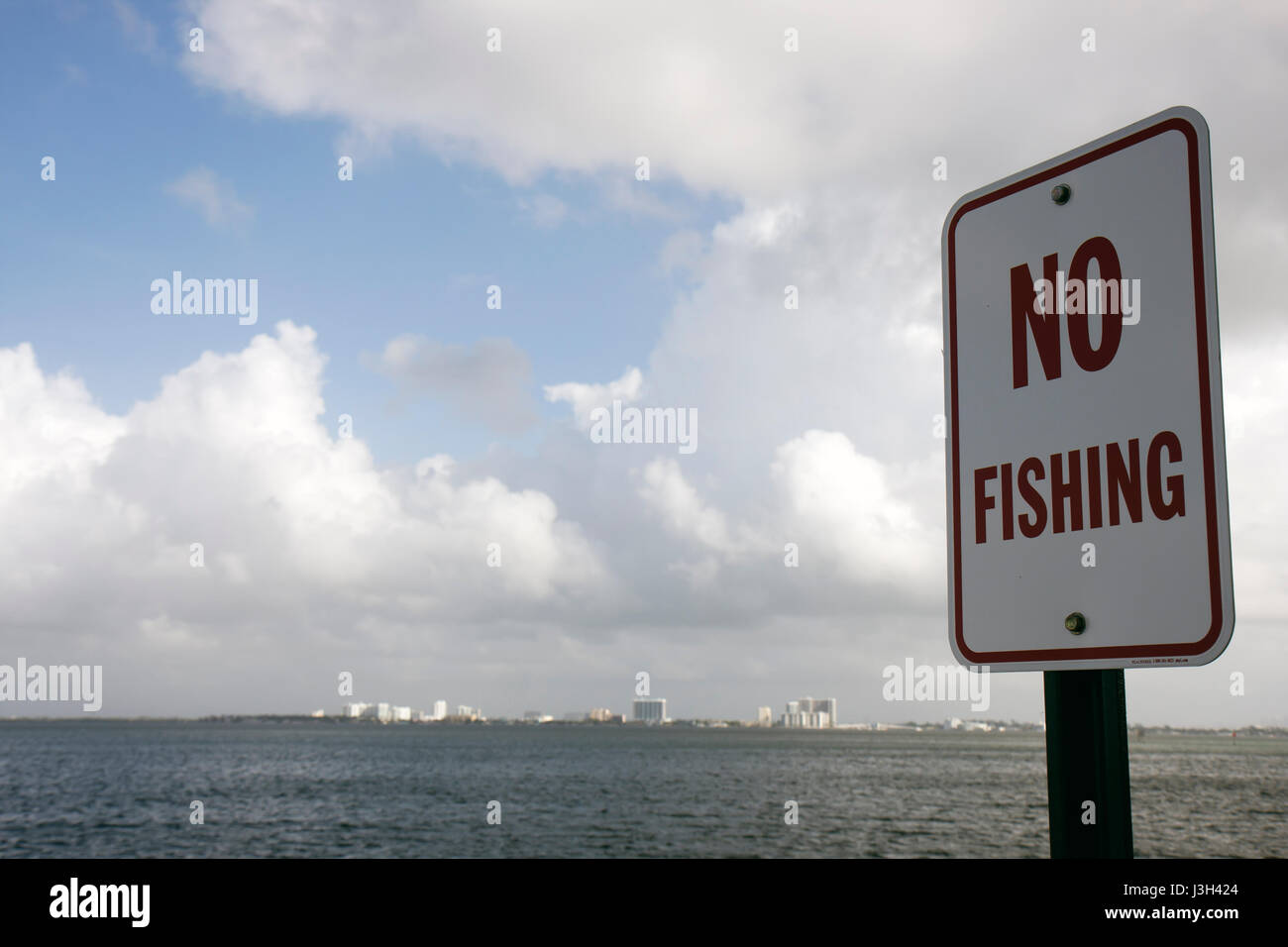 Miami Beach Florida,Biscayne Bay,sign,no fishing,information,regulation,water,sky,clouds,clouds,FL080911079 Stock Photo