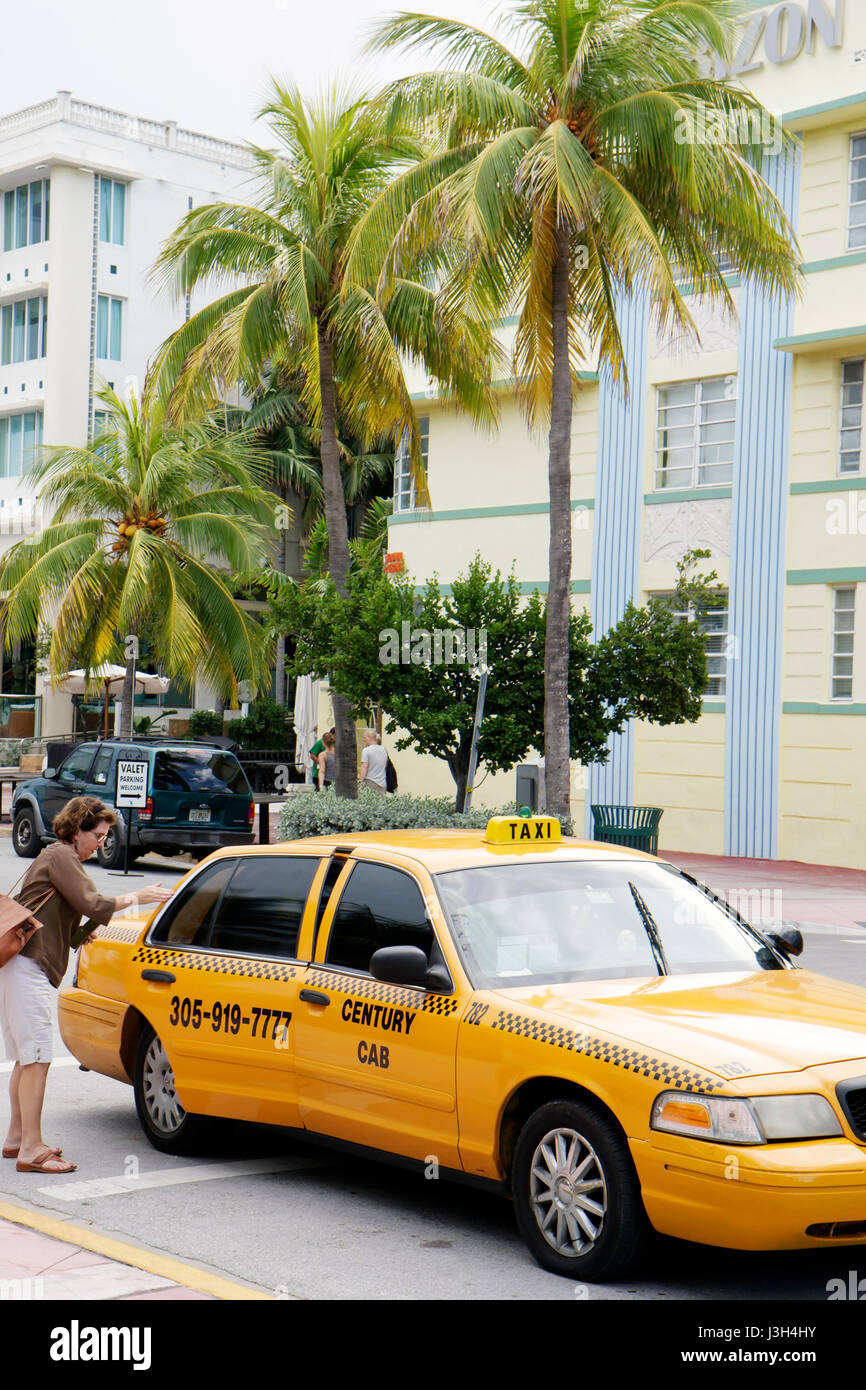 Miami Beach Florida,Ocean Drive,adult adults woman women female lady,taxi,taxis,cab,cabs,taxicab,cabs,public transport,transportation,ride,working,wor Stock Photo
