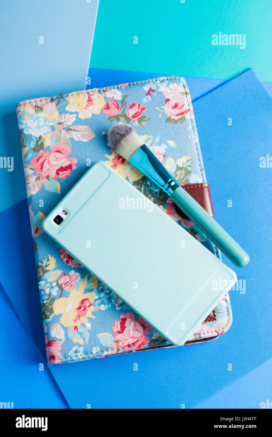 Her Life in shades of blue: Still Life of a tablet, smartphone and a make-up brush placed in a multi-tone shades of blue. Stock Photo