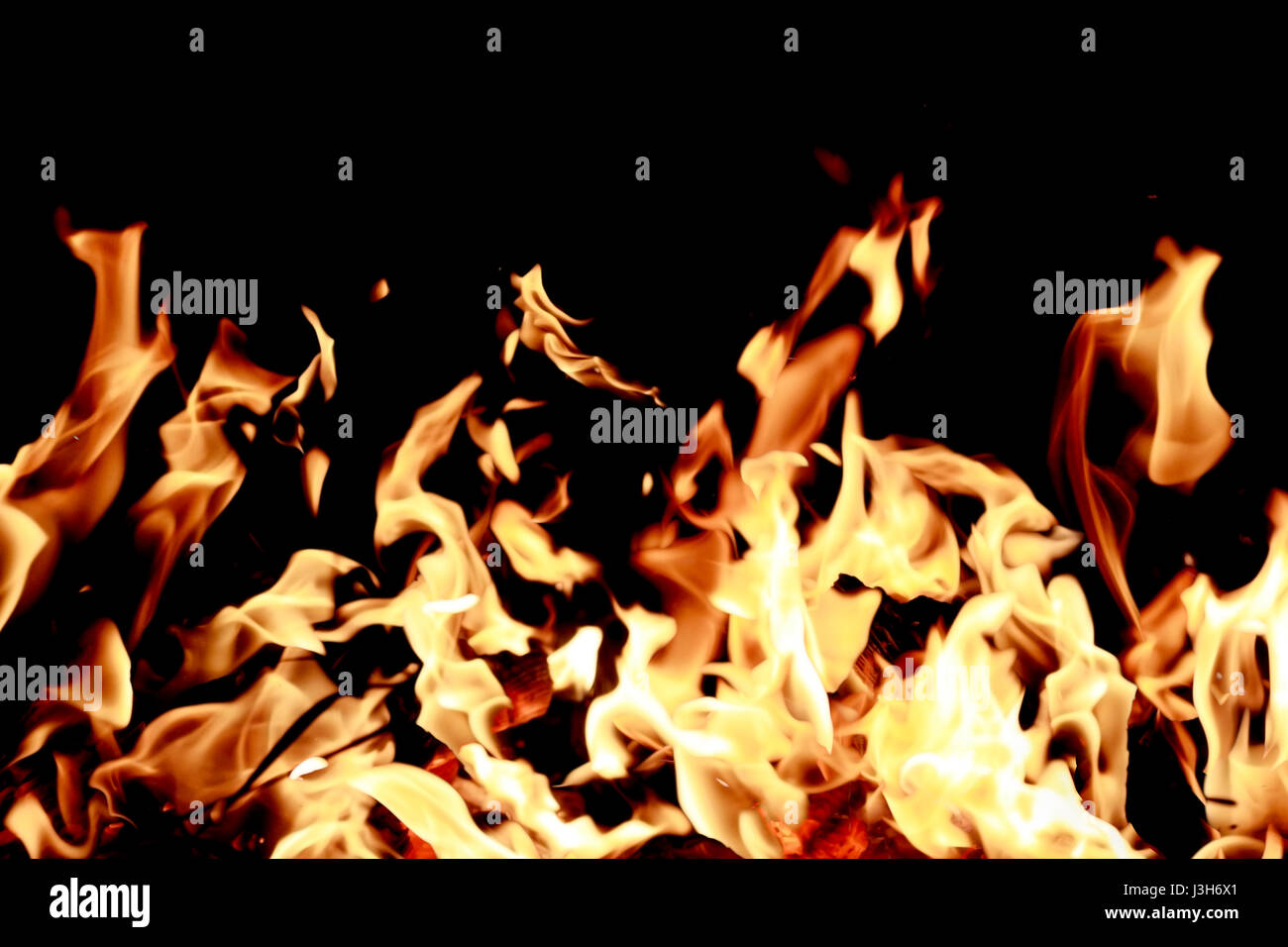 Intense fire isolated over black background Stock Photo - Alamy