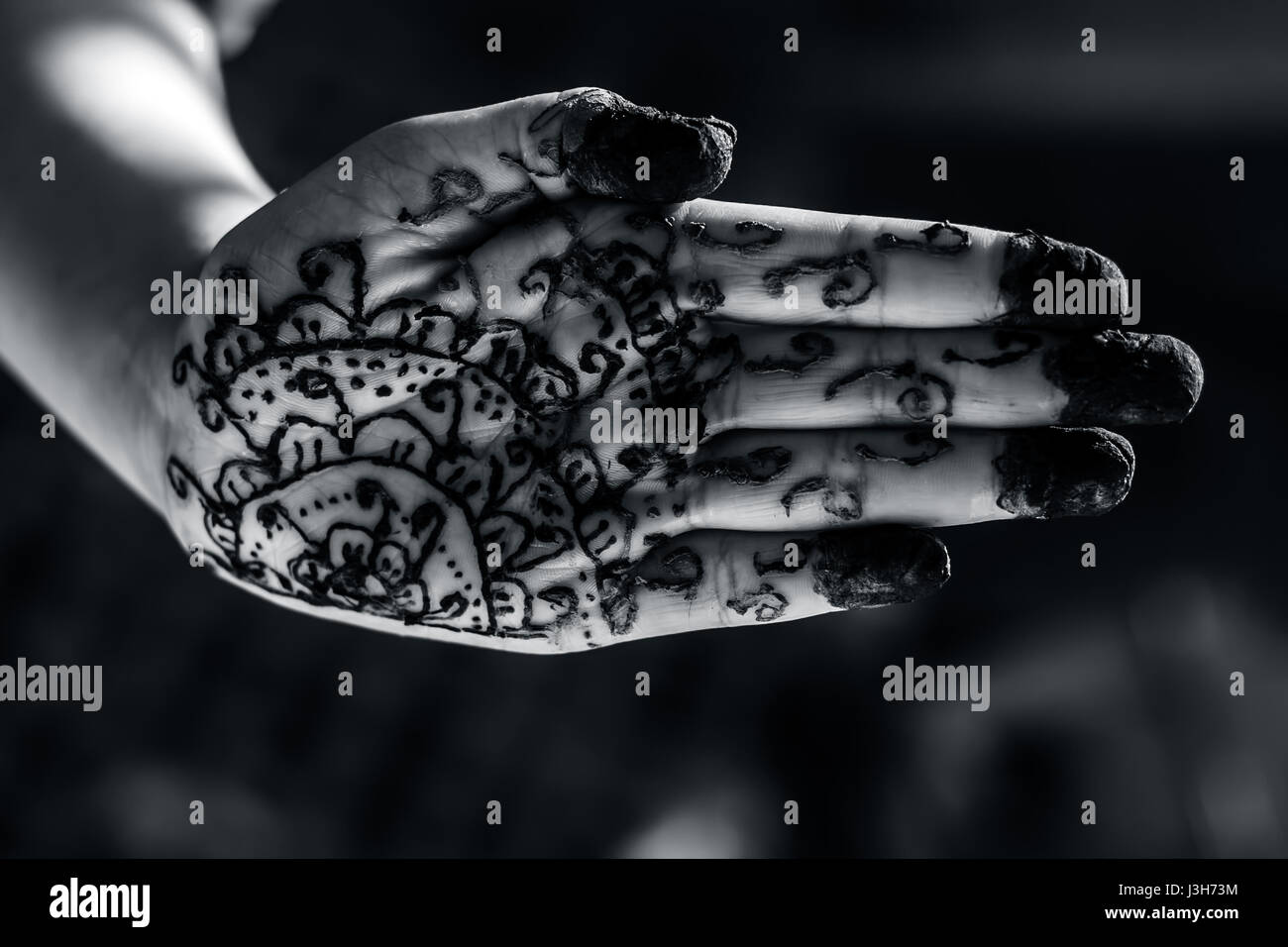 A girl showing his hand decorated with hanna desighn called 'Mehendi' Stock Photo