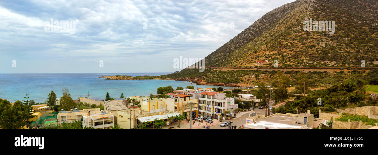 Bali, Greece - May 2, 2016: View from top of hotel Atali Village on Greek architecture of resort town Bali, coast of Livadi Beach and high mountain. C Stock Photo