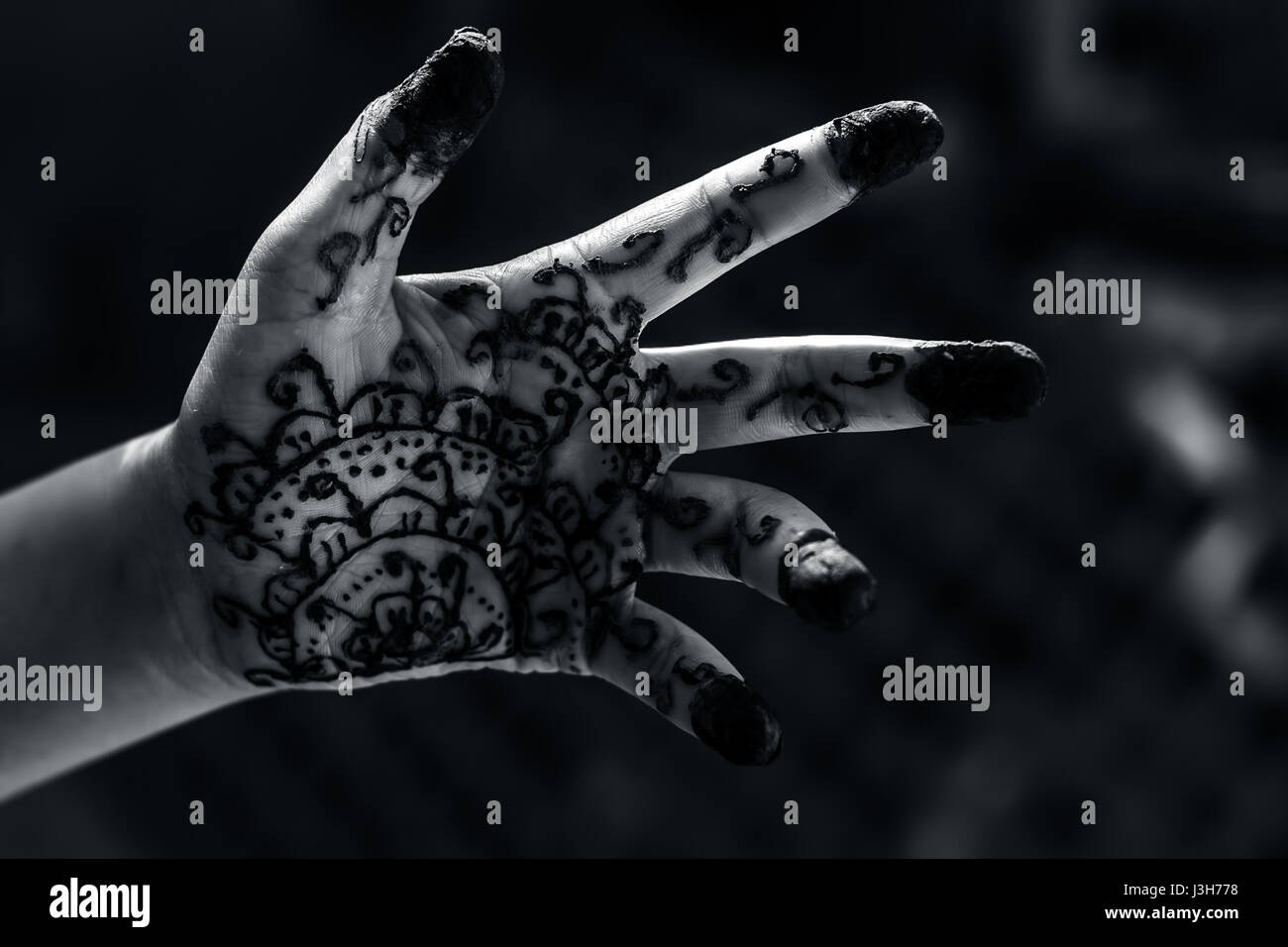 A girl showing his hand decorated with ;Hanna' Stock Photo