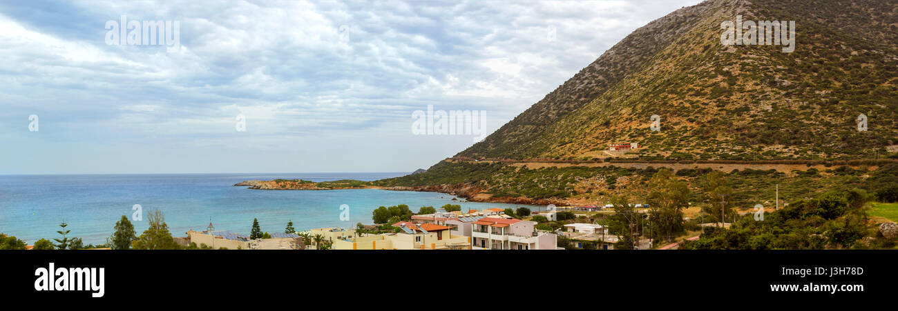 Bali, Greece - May 2, 2016: View from top of hotel Atali Village on Greek architecture of resort town Bali, coast of Livadi Beach and high mountain. C Stock Photo
