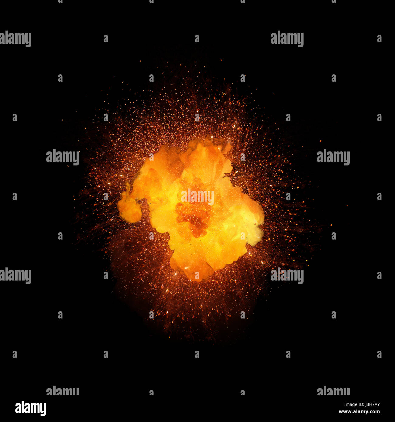 Realistic fiery explosion, orange color with sparks isolated on black