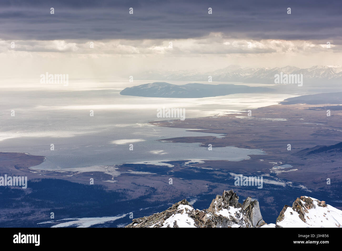 Lake Hovsgol from height of mountains. Low continuous cloud cover. Mongolian-Russian border. Stock Photo