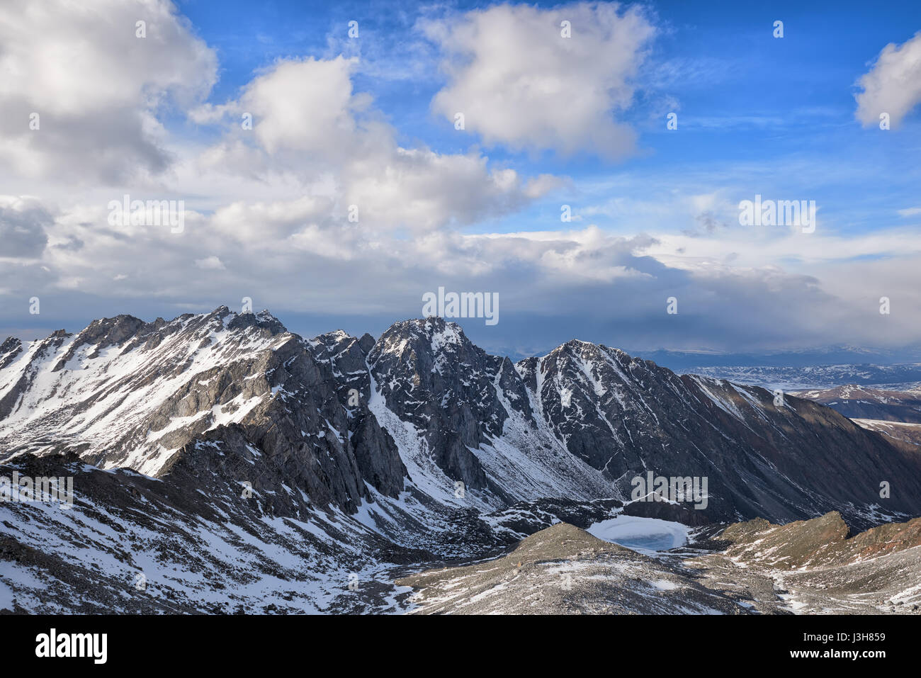 Cumulus clouds over a mountain massif. East Sayan. Russia Stock Photo