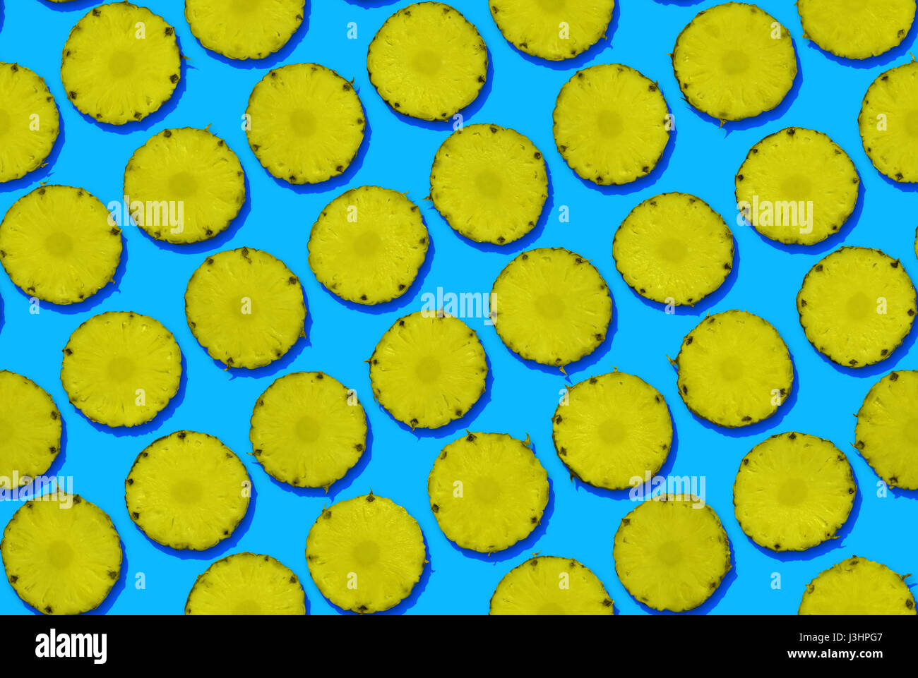 Pineapples on blue background, seamless Stock Photo