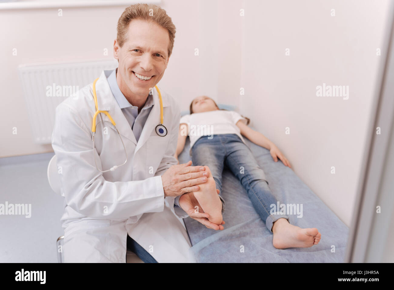 A little check. Competent skillful local rheumatologist conducting a