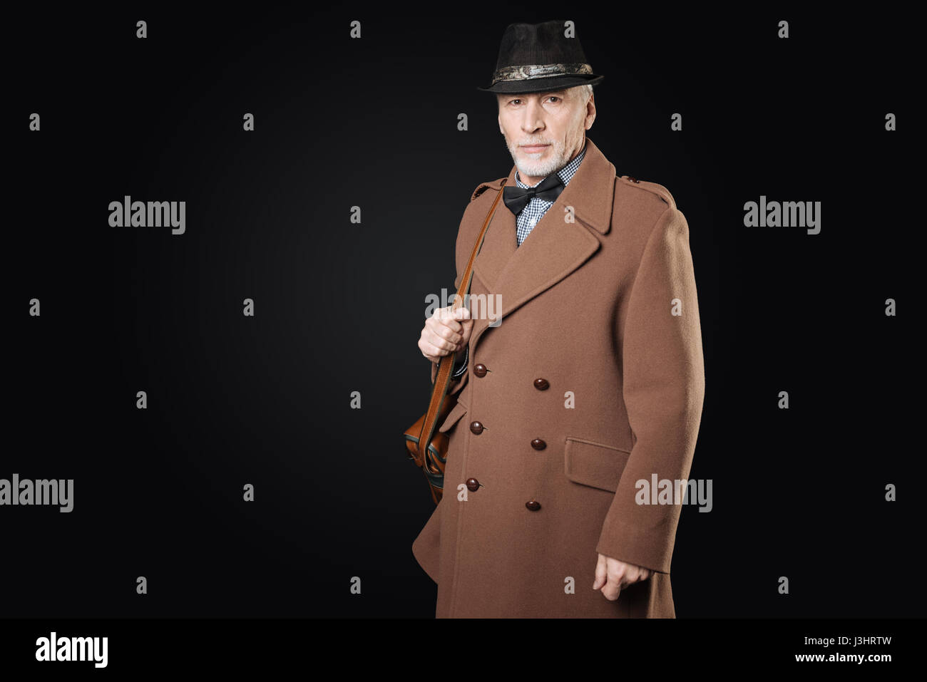 Retro Style Handsome Bearded Grey Haired Man Holding His Bag On